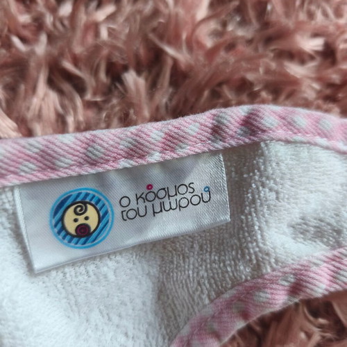 Baby bib "O kosmos tou moro" like new, white with pink details