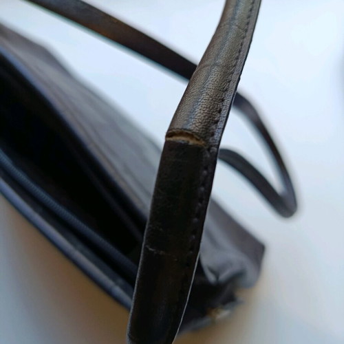Black shoulder bag used with sturdy construction and multiple pockets