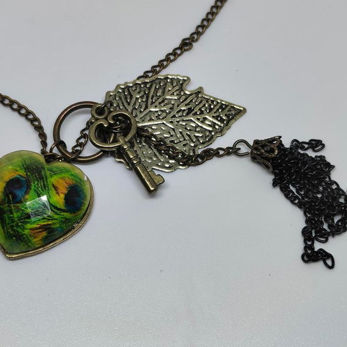 Vintage necklace with antique bronze elements and peacock feather heart pendant like new
