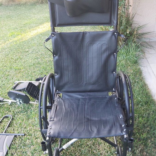 Wheelchair with adjustable reclining backrest and cushion