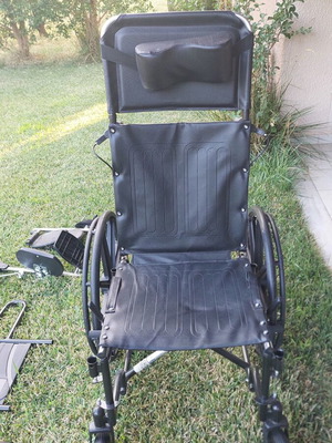 Wheelchair with adjustable reclining backrest and cushion