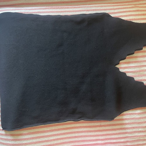 Black knitted sleeveless top with scalloped edges
