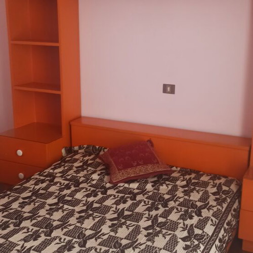 Wooden bedroom set with bed, mattress, nightstands, bookshelf, dresser with mirror