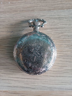 Old pocket watch like new with embossed pattern