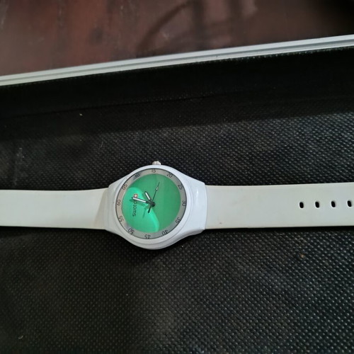 Swatch watch used with white silicone strap and green dial