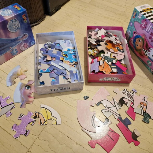 Frozen and Gabby's Dollhouse puzzles used, 52 pieces each