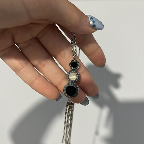 Long necklace with geometric design and tassel, black and silver