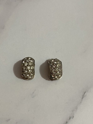 Clip-on earrings with rhinestones used, silver color