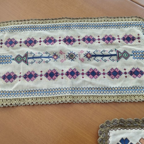 Vintage handmade embroidered table linens with cross-stitch and gold thread