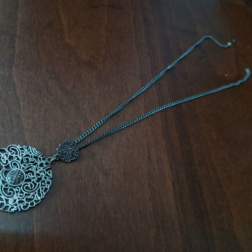 Metal pendant with pierced design used, silver color