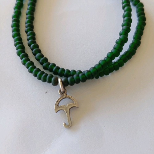 Handmade bracelet with green beads and silver umbrella charm