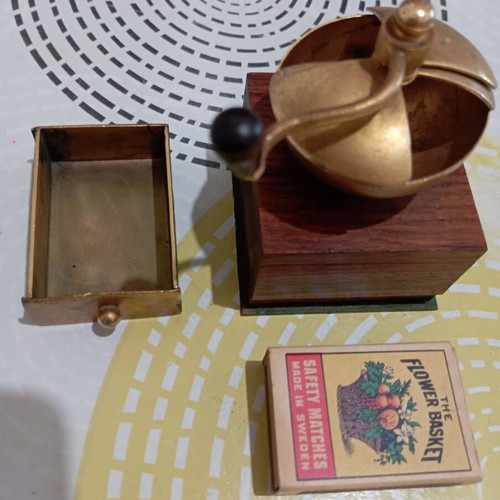 Vintage miniature manual coffee grinder with wooden body and brass hopper