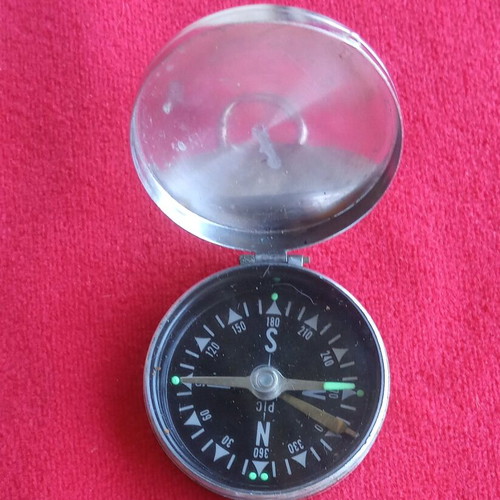 Vintage pocket compass used with metal casing