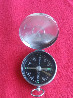 Vintage pocket compass used with metal casing