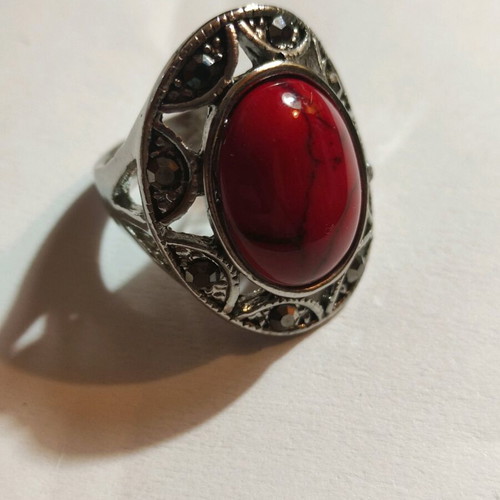 Silver-plated ring with red stone and small crystals new