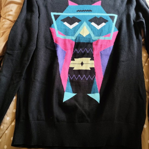 Black sweater used, medium size with loose fit and small hole