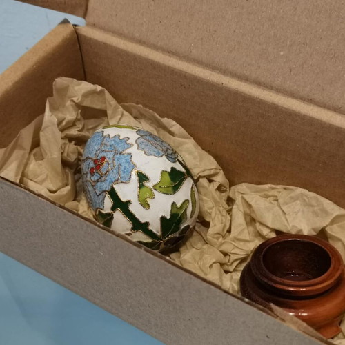 Cloisonne egg used with blue flowers and wooden base