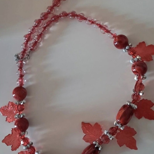 Handmade red necklace with beads and decorative leaves like new