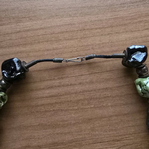 Necklace used with embossed large beads in black and green