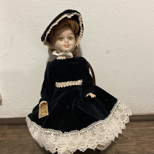 Porcelain doll with velvet dress and wooden chair like new