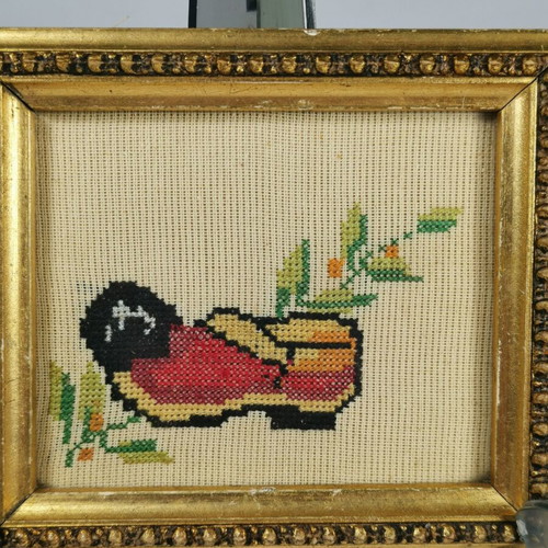 Vintage embroidered frame with traditional tsarouhi used