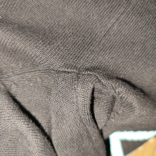 Black sweater used, medium size with loose fit and small hole