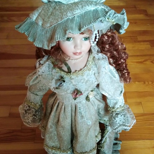 Porcelain doll with green eyes like new