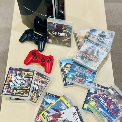 PlayStation 3 Fat 500GB console with 11 games, 2 controllers