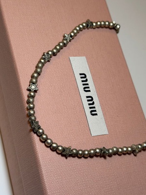 Necklace silver color with bead and star shapes used