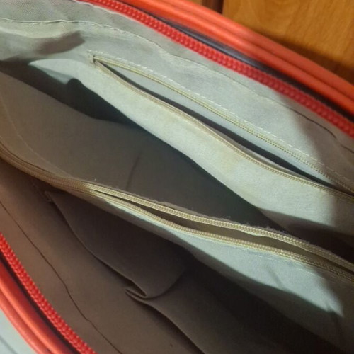 Red shoulder bag used with multiple compartments and zippers