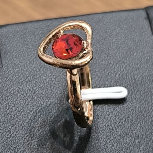 Gold-colored ring with heart and red stone, new
