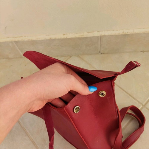 Red backpack used with broken zipper and mark