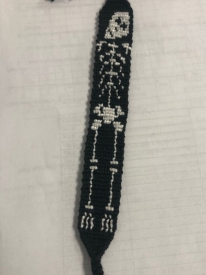 Handmade macrame bracelet for Halloween with skeleton design