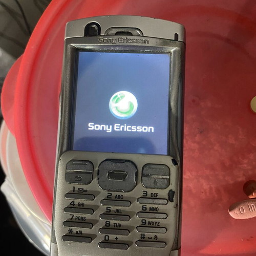 Sony Ericsson P 990i vintage mobile phone used with dock and charger