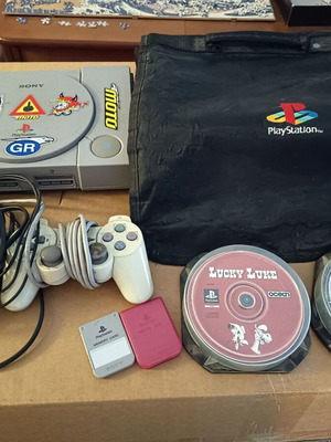Playstation 1 console used with dual shock controller and accessories