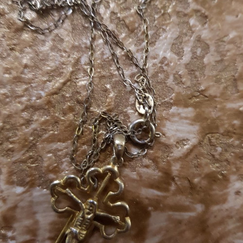 Silver cross used with small diamond