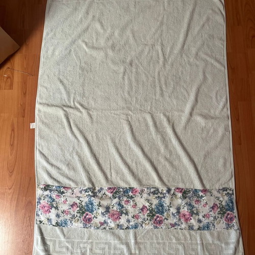Bath towel used, light blue with printed fabric border
