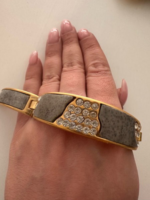 Statement bracelet used with embossed stone and rhinestones gray and gold