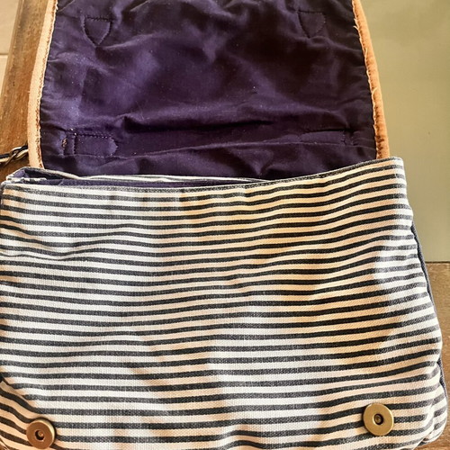 Accessorize vintage crossbody bag with daisies and cherries