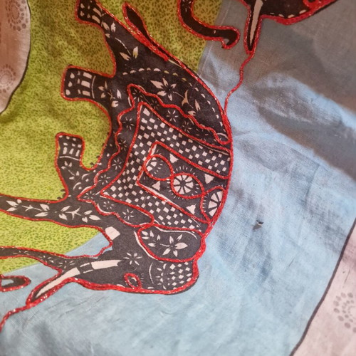 Throw from India used with hand-stitched colorful animal motifs