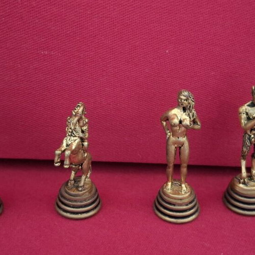 Chess set with decorative metal pieces and black-gold board
