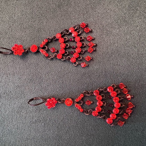 Vintage metal earrings used with red-orange crystals