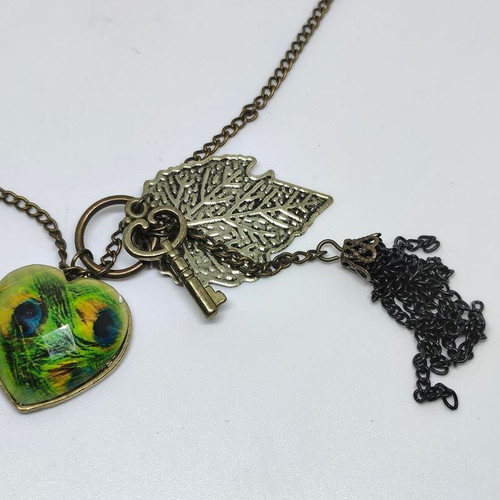 Vintage necklace with antique bronze elements and peacock feather heart pendant like new