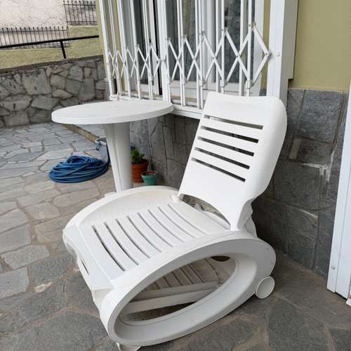 Plastic sun lounger used with wheels and adjustable backrest
