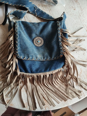 Crossbody denim bag like new with leather fringes and metal detail
