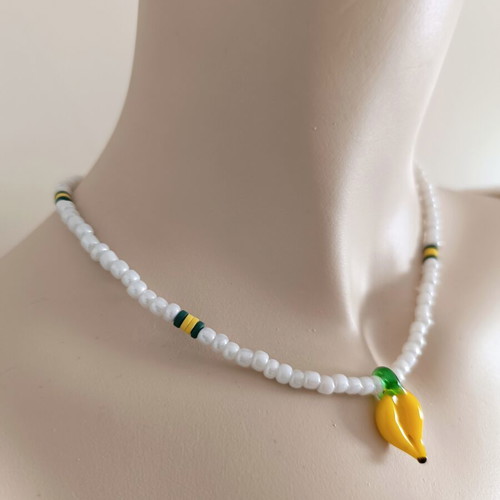 Handmade white short necklace with glass banana pendant