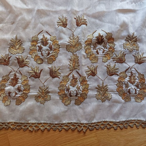 Embroidered table runner used with gold thread and lace