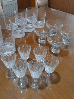 Set of 17 crystal glasses and bowls with carved details