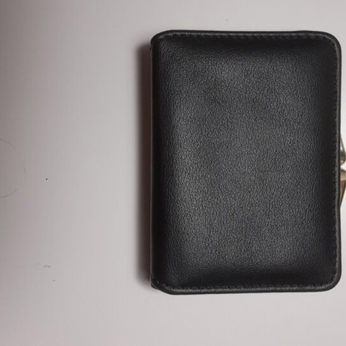 Black wallet new with gold emblem and beige lining