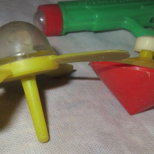 Plastic toys from the 70s like new pistol, flashlight, watch, spinning tops